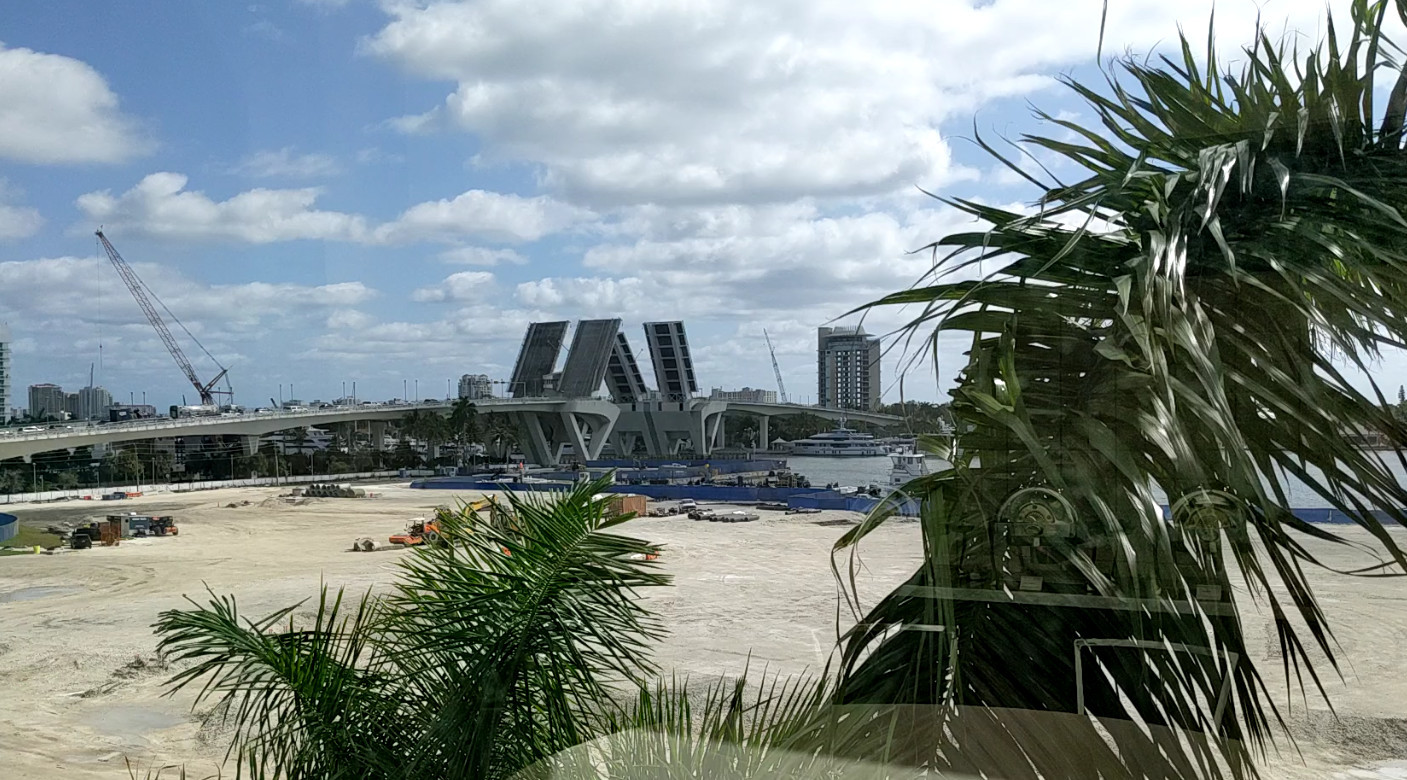 Drawbridge over a bay opening for a boat.