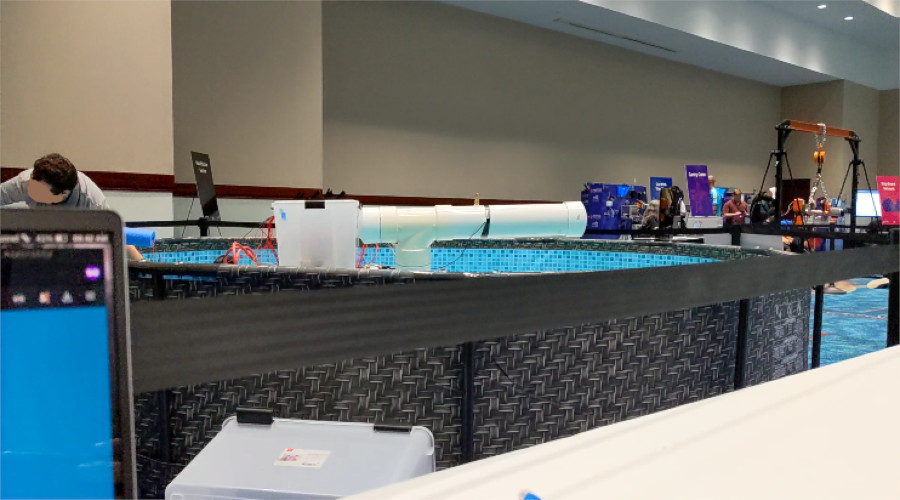 Picture of a kayak in a small above-ground pool with a pump strapped onto it.