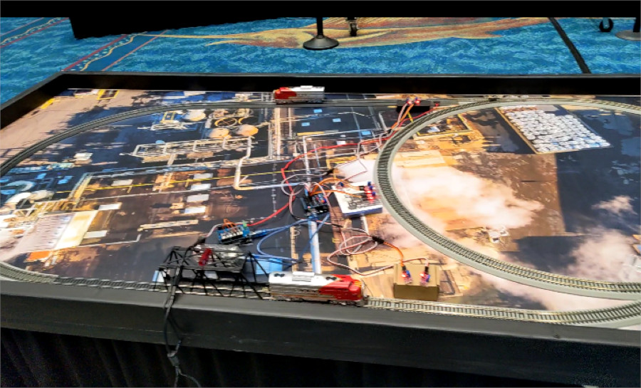 Two model trains on a track, with two Raspberry Pi's powering it..